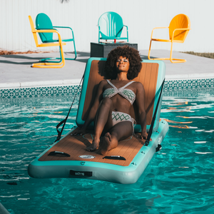 A woman lounging on the Inflatable Hangout Lounge Classic.