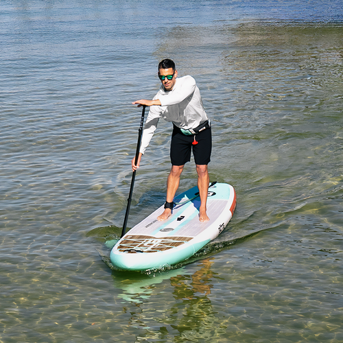 Man paddleboarding on a clear body of water