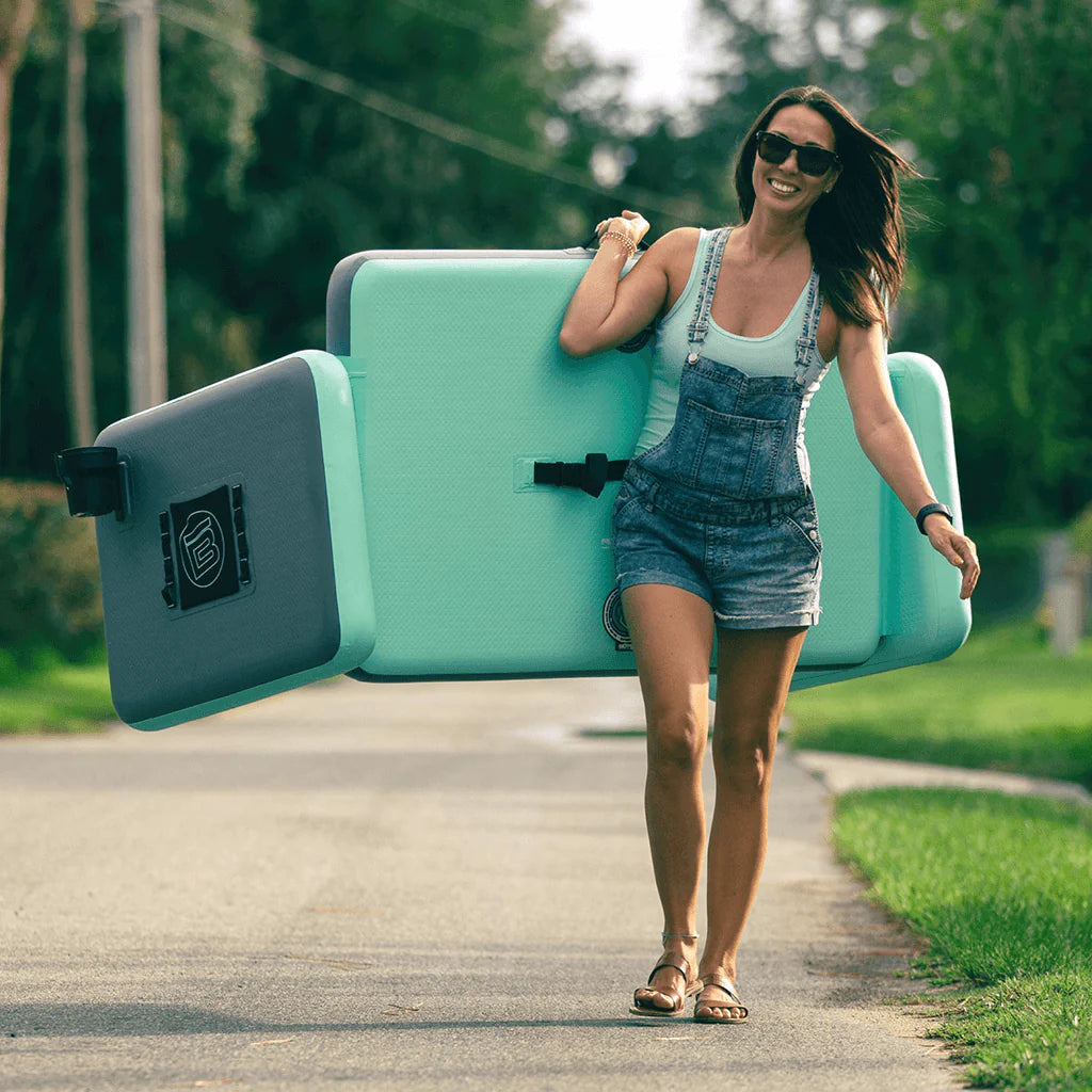 A girl carrying the Aero Couch down the street