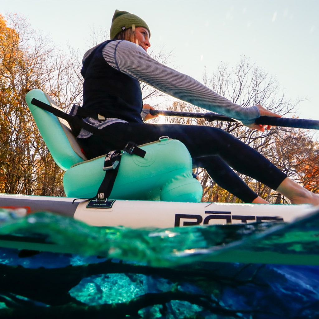 A person paddling using an Aero SUP Seat