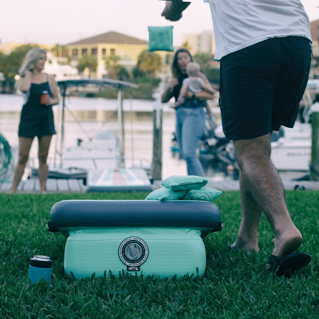 People using the Inflatable Aero Bag Toss Classic in a backyard