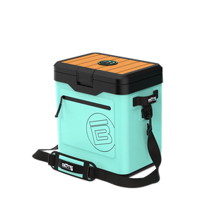 Angled front view of KULA Mule cooler in mint with black lid and shoulder strap.
