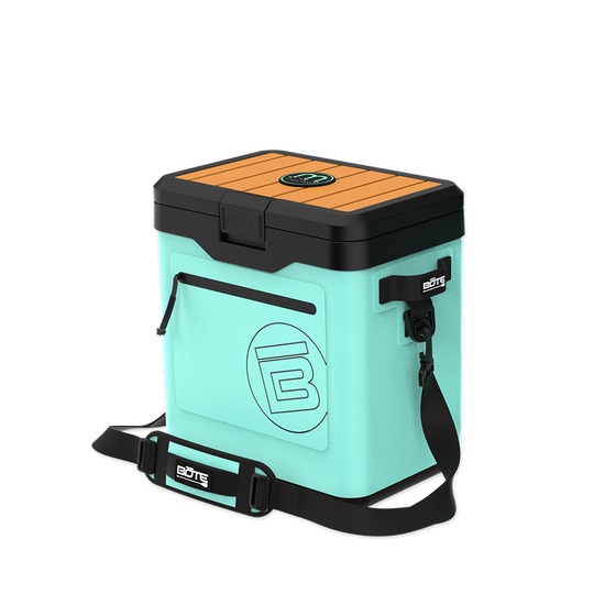 Angled front view of KULA Mule cooler in mint with black lid and shoulder strap.
